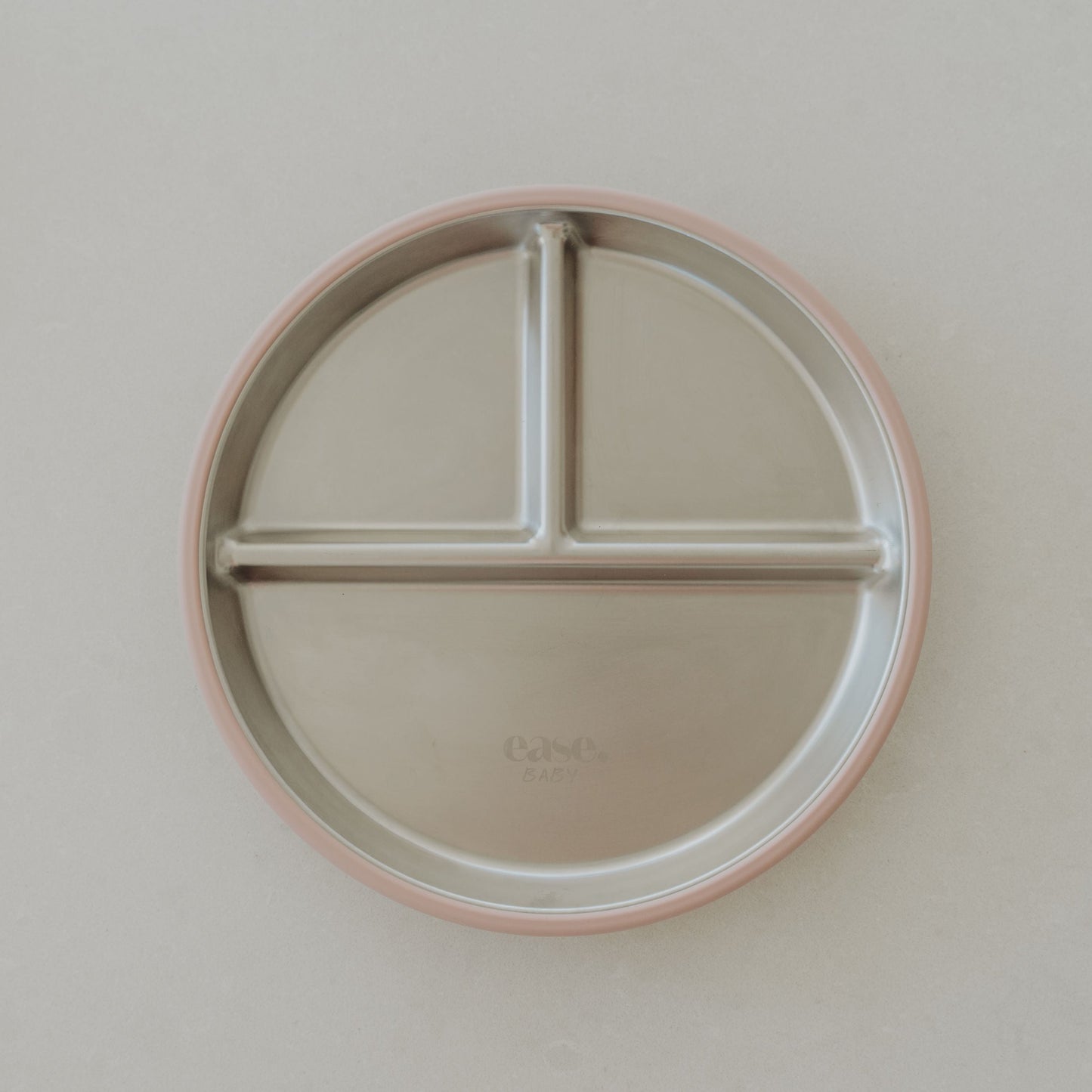 Round plate with three sections on a plain background