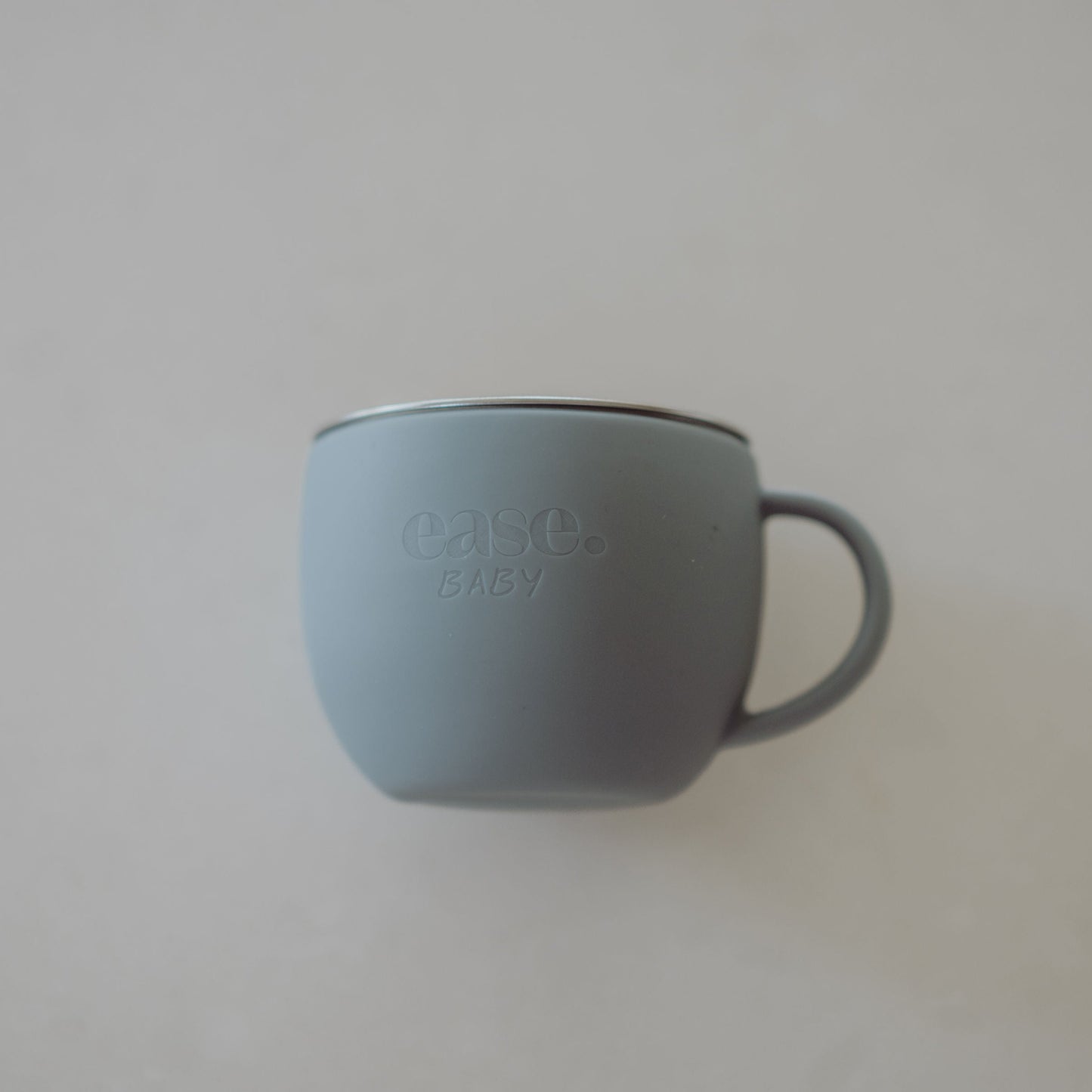 Baby Blue mug with 'ease baby" branding on a light gray background