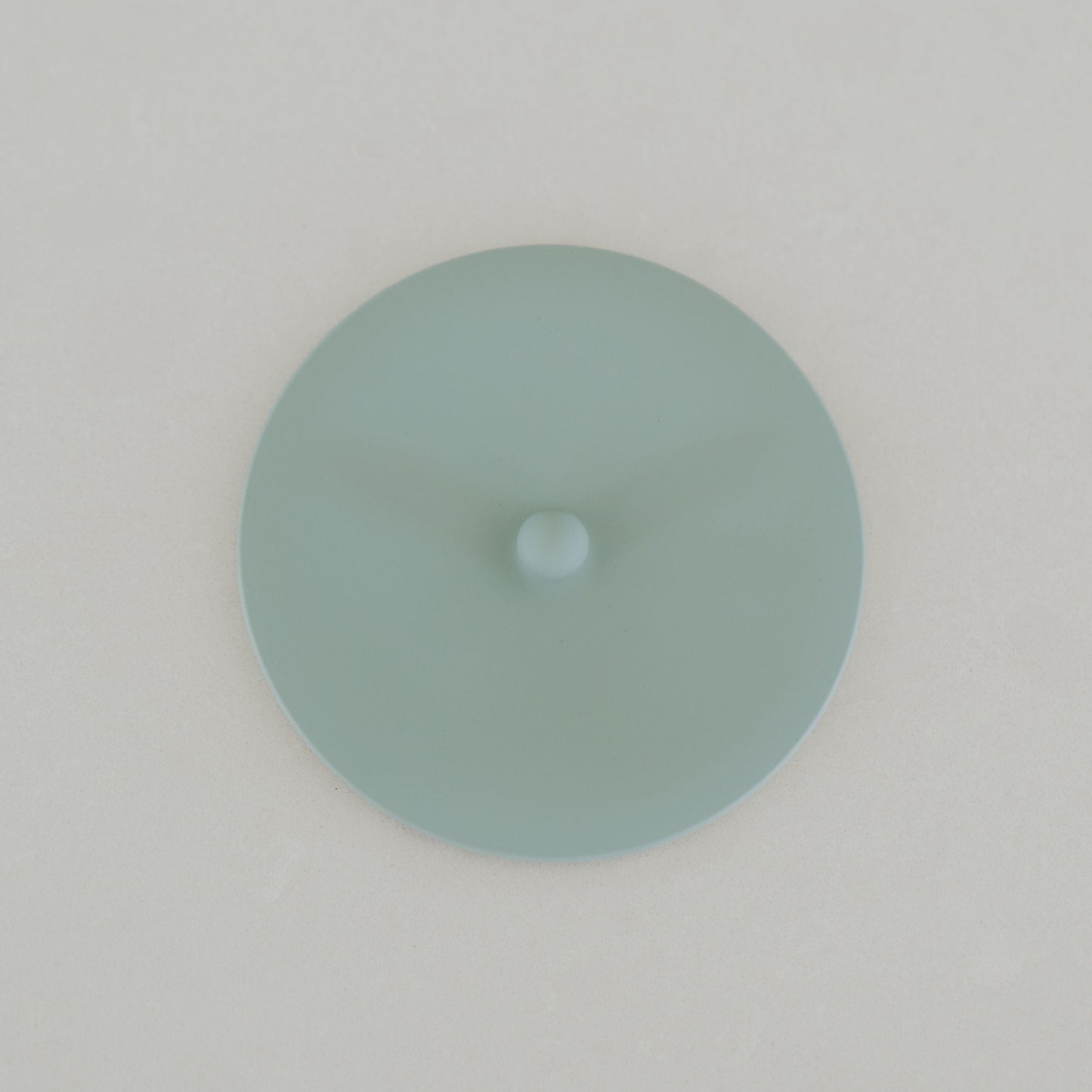 Round light blue object on a white background