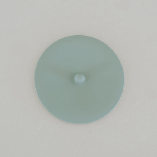 Round light blue object on a white background